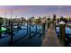 Waterfront dock at twilight with boat lifts and reflecting on the calm water at 3959 Somerset Dr, Sarasota, FL 34242