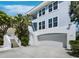 Three-story home with a two-car garage and well-manicured tropical landscaping at 3959 Somerset Dr, Sarasota, FL 34242