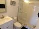 Clean bathroom with white vanity, toilet, and glass-enclosed shower at 4016 Oakview Dr # J6, Punta Gorda, FL 33980