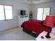 Bright bedroom featuring a comfortable bed, white dresser, and ample natural light at 4016 Oakview Dr # J6, Punta Gorda, FL 33980