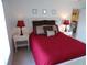 Cozy bedroom featuring a queen bed, bedside tables, and soft lighting at 4016 Oakview Dr # J6, Punta Gorda, FL 33980