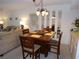 Inviting dining area in the condo with a dark wood table and seating for four, next to the living room at 4016 Oakview Dr # J6, Punta Gorda, FL 33980