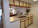Bright kitchen area with a stainless steel sink and dishwasher adjoining the dining and living spaces at 4016 Oakview Dr # J6, Punta Gorda, FL 33980