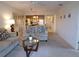Open-concept living room showcasing comfortable seating, a glass coffee table, and easy access to the kitchen at 4016 Oakview Dr # J6, Punta Gorda, FL 33980