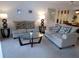 Cozy living room featuring neutral furniture, a glass coffee table, and decorative lamps for a relaxing ambiance at 4016 Oakview Dr # J6, Punta Gorda, FL 33980