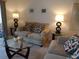 Charming living room featuring cozy sofas, a glass coffee table, and stylish lamps for a warm atmosphere at 4016 Oakview Dr # J6, Punta Gorda, FL 33980