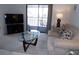 Comfortable living room with a TV, glass coffee table, and sliding doors to a balcony at 4016 Oakview Dr # J6, Punta Gorda, FL 33980