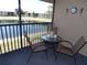 Relaxing patio area with a pond view, furnished with a table and chairs at 4016 Oakview Dr # J6, Punta Gorda, FL 33980