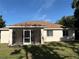 The backyard showcases a screened-in lanai, part of the exterior of the home at 4031 Wake Ave, Sarasota, FL 34241