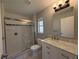 Bathroom featuring a glass shower door, a sink vanity, and a toilet at 4031 Wake Ave, Sarasota, FL 34241