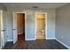 A look into the ensuite bathroom and a closet from this bedroom with wood floors at 4031 Wake Ave, Sarasota, FL 34241