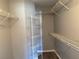 Walk-in closet with a practical shelving system for optimal organization at 4031 Wake Ave, Sarasota, FL 34241