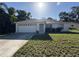 This home features a 2-car garage, a well-maintained lawn, and simple landscaping at 4031 Wake Ave, Sarasota, FL 34241
