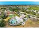 Aerial view showcasing community pool, tennis courts, playground, and surrounding neighborhood at 4426 Useppa Dr, Bradenton, FL 34203