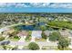An aerial view showcasing a residential neighborhood with homes surrounding a scenic lake and green spaces at 4426 Useppa Dr, Bradenton, FL 34203