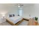 Bright bedroom features two twin beds, ceiling fan, wood-look floors, and natural light from the window at 4426 Useppa Dr, Bradenton, FL 34203