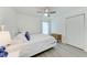 Bright bedroom with white walls, grey wood floor, closet, and ceiling fan at 4426 Useppa Dr, Bradenton, FL 34203