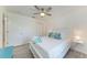 Bright bedroom features queen-size bed, ceiling fan, wood-look floors, and natural light from the window at 4426 Useppa Dr, Bradenton, FL 34203