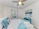 Bright bedroom with a large window and coastal themed decor and an accent dresser at 4426 Useppa Dr, Bradenton, FL 34203