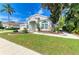Beautiful single-story home featuring lush green lawn, well-maintained landscaping, and an inviting walkway at 4426 Useppa Dr, Bradenton, FL 34203