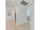 Hallway featuring tile flooring, arched doorway, and access to bathroom, bedroom, and closet space at 4426 Useppa Dr, Bradenton, FL 34203