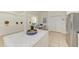 Bright kitchen island with white marble countertop and modern stainless steel appliances adding a touch of elegance at 4426 Useppa Dr, Bradenton, FL 34203