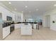 Bright kitchen features white cabinetry, granite countertops and a functional center island with modern stainless steel appliances at 4426 Useppa Dr, Bradenton, FL 34203