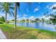 Picturesque waterfront view featuring a serene lake surrounded by lush greenery and neighborhood homes at 4426 Useppa Dr, Bradenton, FL 34203