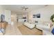Open-concept living room with tile flooring, white sofas and views into the kitchen and entry hall at 4426 Useppa Dr, Bradenton, FL 34203