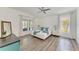 Bright main bedroom with wood floors, a king-size bed, and large windows at 4426 Useppa Dr, Bradenton, FL 34203
