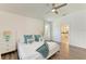 Beautiful main bedroom with wood floors, a king-size bed, and an en-suite bathroom at 4426 Useppa Dr, Bradenton, FL 34203