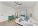 Inviting bedroom featuring wood floors, a comfortable bed, and a view of the backyard at 4426 Useppa Dr, Bradenton, FL 34203