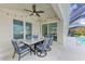 Covered patio area with dining table, chairs, and ceiling fan, great for outdoor entertaining at 4426 Useppa Dr, Bradenton, FL 34203
