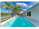 Stunning pool area with hot tub, surrounded by lush landscaping and screened enclosure at 4426 Useppa Dr, Bradenton, FL 34203