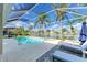 Screened-in pool area overlooking a lake with spa, lounge chairs, and decorative rug at 4426 Useppa Dr, Bradenton, FL 34203