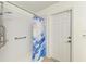 Walk-in shower with handicap bar and detachable head, with decorative shower curtain and tile flooring at 4426 Useppa Dr, Bradenton, FL 34203