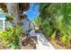 A serene paved walkway, framed by lush greenery and landscaping, offers a tranquil path through the property at 4426 Useppa Dr, Bradenton, FL 34203