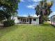 Backyard featuring mature trees and a lush lawn, perfect for outdoor activities at 4845 Boca Raton Ave, Sarasota, FL 34234