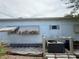 Home exterior featuring vintage awnings and well-maintained utilities at 4845 Boca Raton Ave, Sarasota, FL 34234