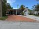 Charming single-story home featuring a screened porch, carport, and well-maintained landscaping at 4845 Boca Raton Ave, Sarasota, FL 34234