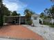 Charming single-story home featuring a screened porch, carport, and well-maintained landscaping at 4845 Boca Raton Ave, Sarasota, FL 34234