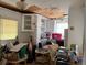 A cluttered kitchen shows white cabinets, damaged ceiling, and a window at 4845 Boca Raton Ave, Sarasota, FL 34234
