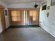 Empty living room featuring vertical blinds and paneled walls at 4845 Boca Raton Ave, Sarasota, FL 34234