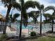 Community pool with lounge chairs behind fence and palm trees at 4845 Boca Raton Ave, Sarasota, FL 34234