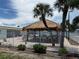 Community poolside bar with picnic tables surrounded by a fence at 4845 Boca Raton Ave, Sarasota, FL 34234