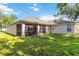 Beautiful home backyard with a screened patio, green lawn, and direct access to the house at 4845 Post Pointe Dr, Sarasota, FL 34233