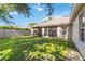 Spacious backyard features a screened-in lanai, green grass, and wood fence, perfect for outdoor enjoyment at 4845 Post Pointe Dr, Sarasota, FL 34233
