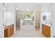 Spacious bathroom with dual vanities, a soaking tub, a separate shower, and tile floors at 4845 Post Pointe Dr, Sarasota, FL 34233