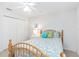 Cozy bedroom featuring a wood bed frame, white walls, and a ceiling fan at 4845 Post Pointe Dr, Sarasota, FL 34233