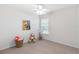 bedroom featuring carpet floors, a ceiling fan, and a window with blinds at 4845 Post Pointe Dr, Sarasota, FL 34233